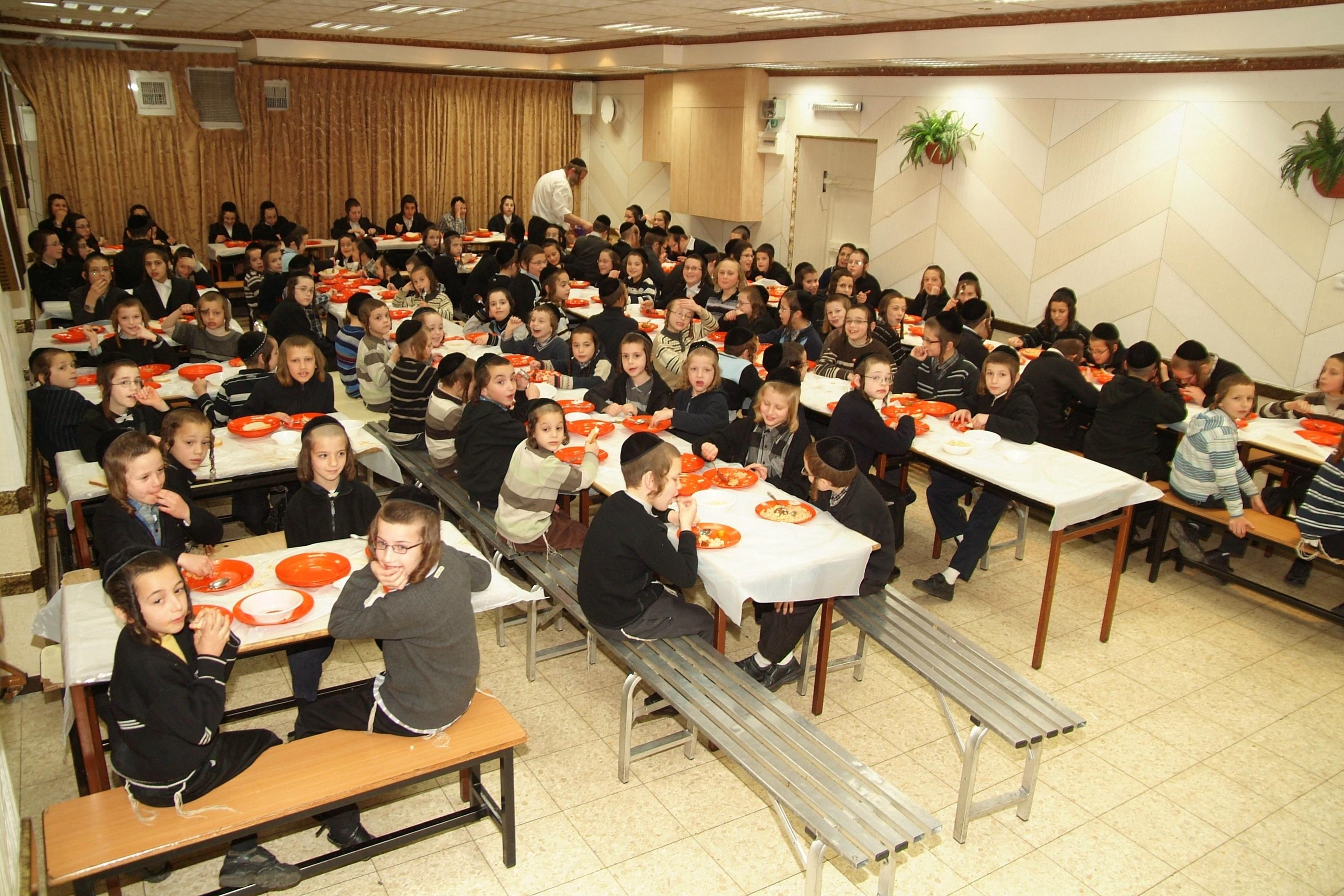 The dining hall laid out with plates before a shift